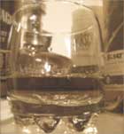 whiskey glass and bourbon bottles